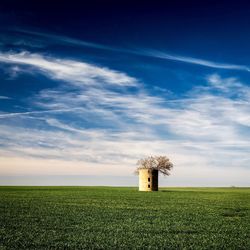 Built structure on field against sky