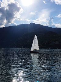 Sailboat sailing on sea against sky