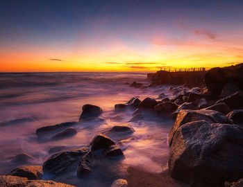 Scenic view of sea against sky during sunset