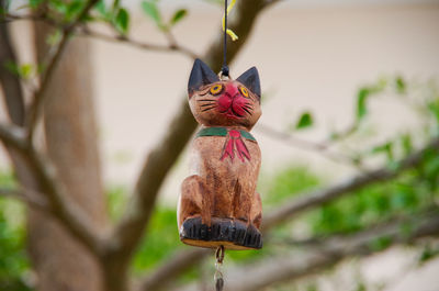 Close-up of animal figurine hanging on tree