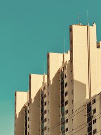 Low angle view of buildings against clear blue sky