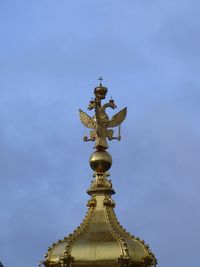 Low angle view of angel sculpture against building