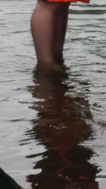 Low section of woman standing in water