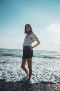 Full length portrait of man standing on beach