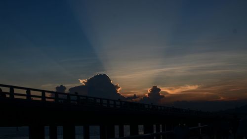 Silhouette bridge against sky during sunset