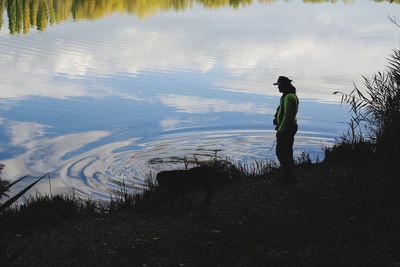 Full length of man standing by lake