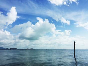 Scenic view of calm sea against cloudy sky