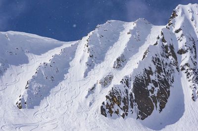 Low angle view of snowcapped mountain against sky