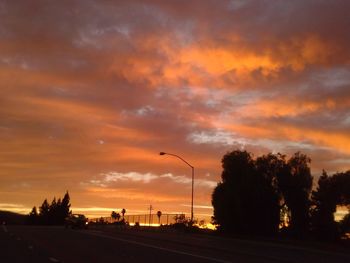 Road against cloudy sky at sunset