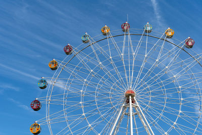 Low angle view of ferris wheel against sky