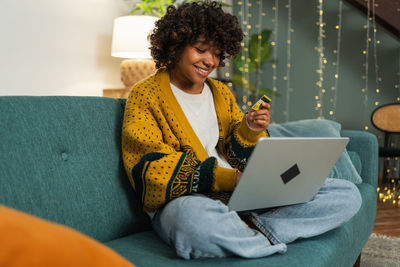 Young woman using laptop at home