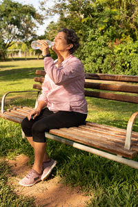 Young woman sitting on bench