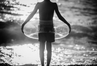 Low angle view of woman holding crystal ball