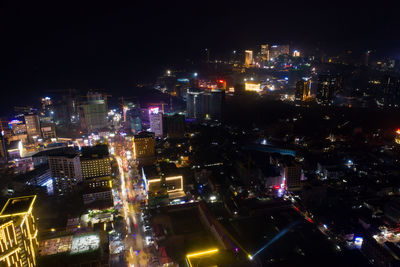 High angle view of illuminated buildings in city at night