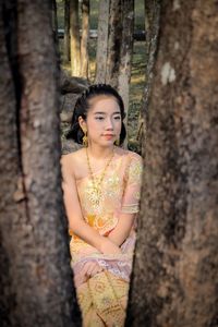 Girl in traditional clothing sitting at park