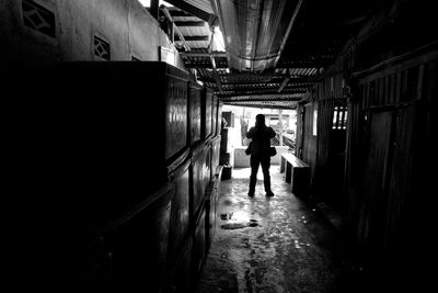 Rear view of woman walking in corridor