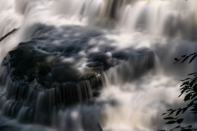 Close-up of waterfall against sky during winter