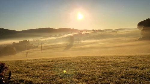 Scenic view of field against sky during sunset