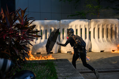 Rear view of man standing on footpath