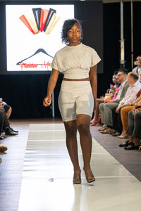 Full length portrait of a smiling young woman