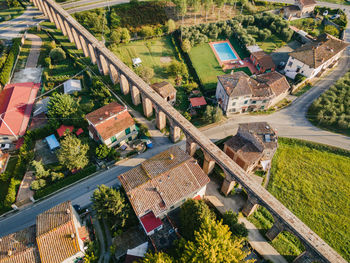 Aerial view old aqueduct and rooftops in italian village. roman arches. acquedotto del nottolini.