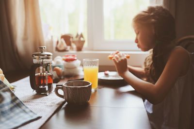 Girl having breakfast at home