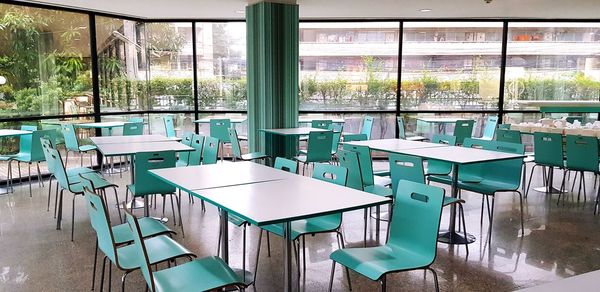 Empty chairs and tables in restaurant