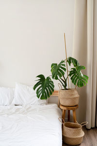 Space at home with bed, monstera and laundry baskets