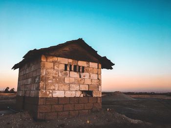 Old building against sky during sunset