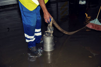 Low section of man working on garbage