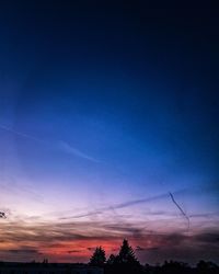 Low angle view of silhouette trees against sky at sunset