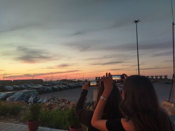 Women photographing sky during sunset