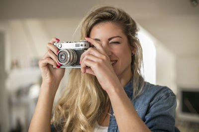Close-up of young woman photographing