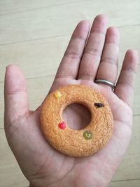 Close-up high angle view of a hand holding doughnut