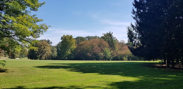 Scenic view of golf course against sky