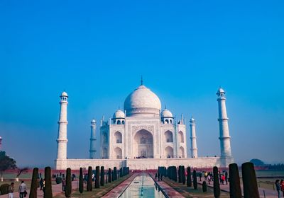 Group of people in front of building against clear sky