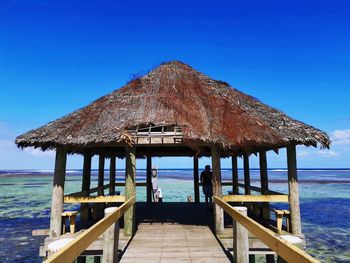 Built structure on beach against clear blue sky