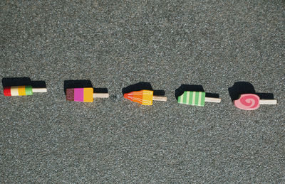 High angle view of multi colored popsicles on road