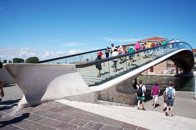 People walking on built structure against sky