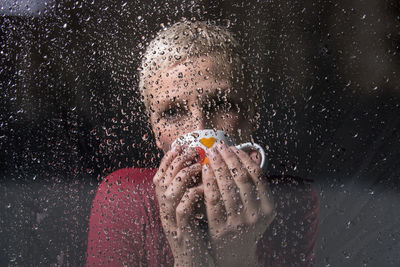 Woman seen through wet glass