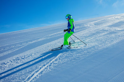 Low angle view of man skiing on snow covered landscape