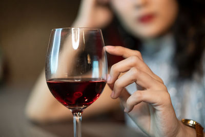 Close-up of woman drinking glass