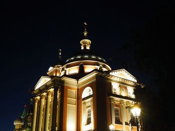 Low angle view of illuminated building against sky at night