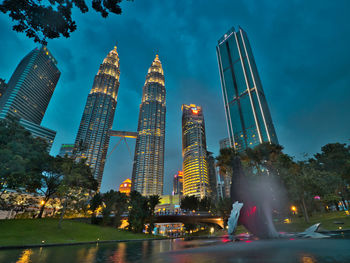 Low angle view of illuminated buildings against sky