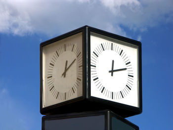 Street clock against blue sky
