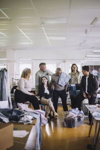 Happy male and female fashion designers enjoying at workshop