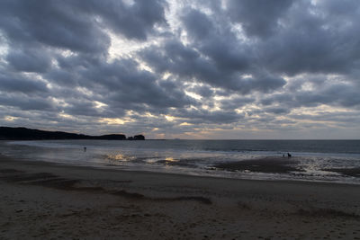 Scenic view of beach against sky during sunset