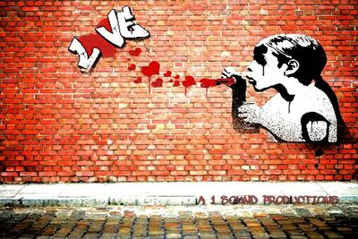 Woman lying on brick wall