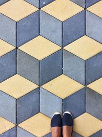 Low section of person on tiled floor