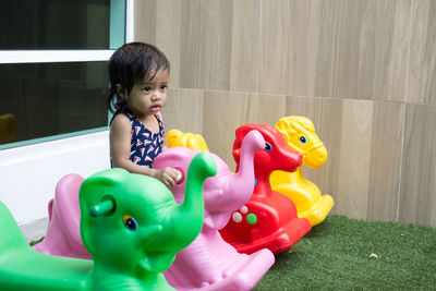 Cute baby girl with toy toys